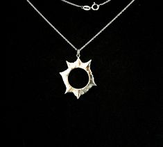 The mysteries of our solar system always get our imagination aroused. Watching a solar eclipse gives us this feeling of us being part of a great universe. When the moon blocks the sun it is a rare, fascinating, magical moment. I love to carry this moment around with me ----Details---- A solar eclipse pendant from solid sterling silver hand carved using the lost wax method. hole diameter: 16mm 0,62inch comes on a 18 inch/ 45cm long black sterling silver chain.If you would like a 20 inch / 50cm long chain please leave me a note in the message to seller form when checking out. If you choose the 18k goldplated option, it comes with an 18 inch/ 45 cm long gold filled chain The front side is glossy, the rear side is matte. Please check the solar eclipse earrings pair listing: https://www.etsy.co Sterling Silver Sun Design Jewelry, Unique Round Jewelry With Sun Design, Unique Round Sun Design Jewelry, Silver Sun And Moon Medallion Jewelry, Silver Medallion Jewelry With Sun And Moon Design, Unique Sterling Silver Sun And Moon Jewelry, Sterling Silver Jewelry With Sun Design, Eclipse Jewelry, Moon Surface