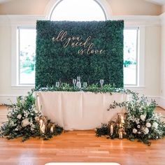 the table is set up with candles and greenery