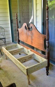 a wooden bed frame sitting on top of a patio