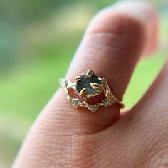 a close up of a person's hand with a ring on their finger,