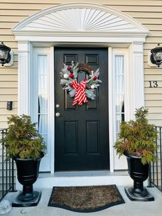 a front door decorated with christmas wreaths and decorations