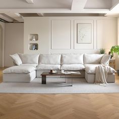 a white couch sitting on top of a wooden floor