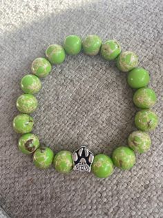 "This super neat, green apple colored beaded bracelet is super stylish! It is finished with a silver tone paw charm saying \"cat mom\"in the center. Your friends will surely be jealous when they see you wearing this! This is made with clear stretch cord and is 7 inches in length but I can adjust it if needed, just request at checkout!  This is an absolutely gorgeous bracelet and would be a great birthday present, anniversary present, Valentine's Day  present, Christmas present; or graduation gif Nickel-free Green Beaded Bracelets As A Gift, Nickel-free Green Beaded Bracelets For Gift, Nickel-free Green Beaded Bracelet For Gift, Green Nickel-free Bracelets For Gifts, Green Nickel-free Beaded Bracelets As A Gift, Casual Green Beaded Bracelets With 8mm Beads, Green Nickel Free Bracelets With Round Beads, Personalized Green Bracelets With Round Beads, Green Personalized Bracelets With Round Beads