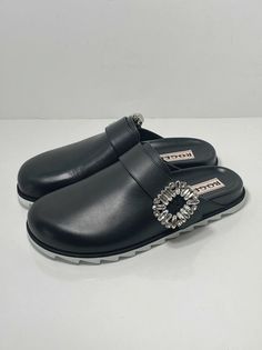 Roger Vivier Slidy Crystal-buckled Leather Backless Loafers size 37. New never worn with box and dust bag. Size 37, fits us size 7 Fainted scratches on the right shoe from handling. 100% Authentic guaranteed Retail for $1200 Made from polished black leather, they're embellished with signature crystal strass buckles for a bit of glamour, while ergonomic footbeds and shark-tooth soles lend them practicality. upper: leather lining: leather sole: leather insole, rubber sole round toe Made in Italy Line cross the label as final sale Designer Leather Sole Sandals For Work, Modern Mules With Tang Buckle And Round Toe, Luxury Slip-on Loafers With Tang Buckle, Leather Slip-on Loafers With Buckle Closure, Modern Slip-on Mules With Buckle Closure, Luxury Slip-on Loafers With Buckle Closure, Designer Round Toe Mules With Buckle Closure, Designer Mules With Buckle Closure And Round Toe, Designer Round Toe Sandals For Work