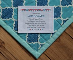 a blue and white quilted place mat with a name tag on it that reads, personalized james sayer