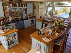 a kitchen filled with lots of counter space next to a wooden dining room table and chairs