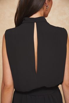 the back of a woman's black dress with an open neck and cutout