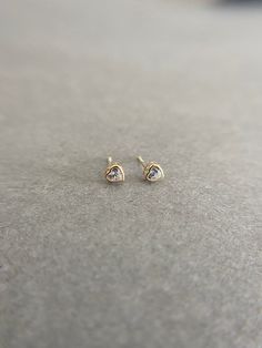 SCREW BACK/14K Solid Gold CZ Heart Bezel Stud Earrings- 14K Solid Gold Quantity: One Pair Color : Clear / Blue / Pink Materials : 14K Solid Gold Size : 4mm *14K Solid Gold will not tarnish. *Good for sensitive skin. * Metal components are 14K Solid Gold including earring backs. * Suitable for delicate and sensitive ears. * Comes in a jewelry box. If you need extra boxes for gifting....just let us know! Elegant Gold Heart Earrings With Birthstone, Gold Heart Earrings With Prong Setting In 14k Gold, Gold 14k Heart Earrings With Prong Setting, Gold Diamond Heart Earrings In Dainty Style, Dainty Diamond Heart Earrings In Gold, Dainty Gold Diamond Heart Earrings, Gold Heart Cut Birthstone Earrings, 14k Gold Heart Earrings For Anniversary, 14k Gold Round Heart Earrings For Anniversary