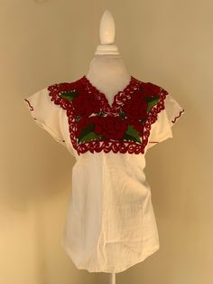 Embroidered Mexican blouse with  red roses. No tag but measures a size large. In good condition. Gorgeous vibrant colors. Casual Red Blouse With Floral Embroidery, Red Crew Neck Blouse With Floral Embroidery, Red V-neck Blouse With Floral Embroidery, Red Short Sleeve Top With Embroidered Hem, Casual Red Tops With Embroidered Hem, Vintage Embroidered V-neck Top, Red Floral Embroidered Short Sleeve Blouse, Red Short Sleeve Blouse With Embroidered Neckline, Traditional V-neck Top With Floral Embroidery