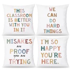 four decorative pillows with words on them