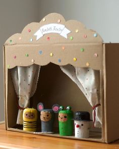 an open cardboard box with little toy animals in it's front and side opening