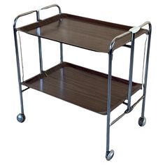 two tiered serving cart with wheels on each side and one shelf attached to the back