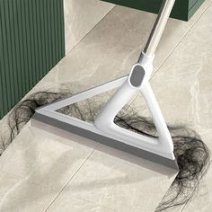 a mop is laying on the floor next to some hair