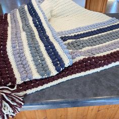 a crocheted blanket sitting on top of a counter