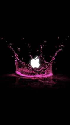 an apple logo with water splashing on it