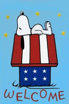 a snoopy dog is sleeping on top of a box with the word welcome written in red, white and blue