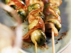 the skewers are covered with vegetables and sauce