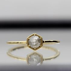 a gold ring with a white diamond on it