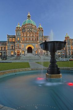 a large building with a fountain in front of it