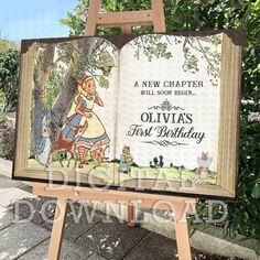 an open book sitting on top of a wooden easel next to a tree and sidewalk