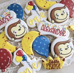 decorated cookies in the shape of monkeys and balloons