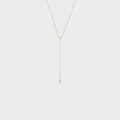 This dainty and sophisticated piece is the perfect addition to any collection! Minimalist Teardrop Jewelry With Diamond Accents, Minimalist Diamond Teardrop Pendant Jewelry, Elegant Rose Gold Solitaire Necklace With Delicate Chain, Minimalist 14k Yellow Gold Lariat Necklace, Diamond Lariat Necklace With Delicate Chain, Dainty Teardrop Necklace With Single Diamond, Classic Everyday Diamond Necklace With Adjustable Chain, Elegant White Gold Drop Lariat Necklace, Formal White Gold Drop Lariat Necklace