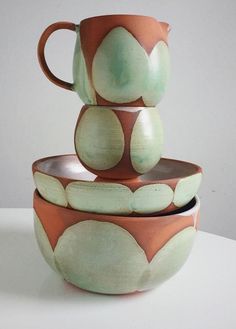 three bowls stacked on top of each other with one bowl in the middle and two cups at the bottom