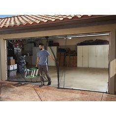 a man walking in front of a garage door