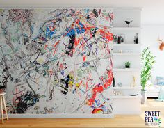 an abstract painting on the wall in a living room