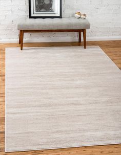 a white rug with a bench in front of it