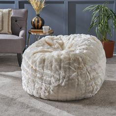 a living room filled with furniture and a large white poufce bean bag chair