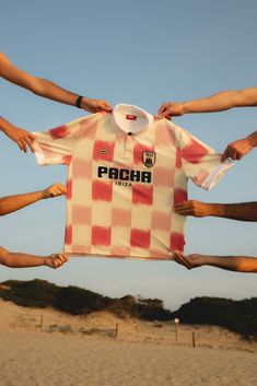 a group of people holding up a shirt with the word pacba on it in front of them