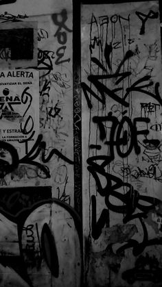 black and white photograph of graffiti on two doors