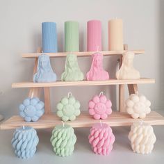 a shelf filled with lots of different colored candles