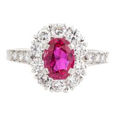 This is part of Chairish’s Fine Jewelry assortment.  Vintage Tiffany & Co ruby & diamond cluster ring crafted in 900 platinum (circa 1960s).    Oval mixed cut natural ruby measures 7.1 x 5.4 x 3.0mm (estimated at 1 carat). Color and inclusions are typical of rubies from Burma (Myanmar). There is no evidence of any treatments to the ruby. Sixteen diamonds total an estimated 0.70 carats (estimated at F-G color and VS clarity). The ruby is in good condition with two tiny chips evident (visible unde Oval Ruby Ring In Platinum For Anniversary, Oval Ruby Ring With Platinum Center Stone, Oval Ruby Ring With Platinum Band, Oval Ruby Ring With Platinum Setting, Oval Ruby Ring With Platinum, Classic Cluster Ruby Ring, Classic Ruby Ring With Rose Cut Diamond Cluster, Cluster Ruby Diamond Ring With Center Stone, White Gold Ruby Cluster Ring With Brilliant Cut