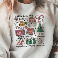 Wrap yourself in the spirit of the season with our 'Retro Christmas Cheer Icon Sweatshirt'. Each sweatshirt, crafted by our small business, features a playful array of holiday icons, from Santa and candy canes to cozy sweaters and gift-giving delights. Perfect for holiday parties or just spreading cheer, our sweatshirt is available in a selection of colors and sizes. Dive into the holiday festivities with this must-have piece by visiting our website and choosing your favorite today! Please choos Casual Holiday Sweater With Graphic Print, Casual Graphic Print Holiday Sweatshirt, Christmas Cotton Sweatshirt With Graphic Print, Casual Graphic Print Sweatshirt For Holiday, Casual Holiday Sweatshirt With Graphic Print, Holiday Graphic Print Sweater, Christmas Graphic Print Holiday Sweatshirt, Holiday Graphic Print Sweatshirt, Holiday Sweatshirt With Graphic Print