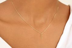 This necklace features a delicate 18K gold-filled tiny cross pendant and a dainty chain.  A beautiful and affordable alternative to solid gold. 18k Gold filled laminate is an excellent option for long-lasting pieces. High quality guaranteed (NO TARNISH). Complement this necklace with a little cross-matching earring  https://www.etsy.com/listing/1455151975   D E T A I L S  * Cross measures  7mm x 12mm * Dainty 0.5 mm chain box   18K  G O L D  F I L L E D   Our gold-filled Chains are made with 5% Simple Yellow Gold Charm Necklace With Adjustable Chain, Minimalist Cross Pendant Necklace With Clavicle Chain, Simple 14k Yellow Gold Charm Necklaces, Simple 14k Gold Charm Necklace, Simple 14k Yellow Gold Charm Necklace, Gold Cross Necklace With Dainty Chain, Simple Tiny Gold Charm Necklace, Yellow Gold Cross Charm Necklace With Delicate Chain, Minimalist Yellow Gold Cross Necklace With Clavicle Chain