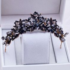 Inspired by the old days of royalty when times were filled with extravagant parties and lavish luxuries, this unique tiara conveys a modern take on old elegance and grand entrances. Adorned with black rhinestones and intricately faceted Swarovski crystals that work their way across the band in a swirly pattern, this is a hair accessory that can complete the most sophisticated of gothic bridal looks. Cast in lightweight bronze alloy, the tiara measures 1.75" at the tallest point (approx. 4.5cm) a Veil Tiara, Black Tiara, Crown Aesthetic, Bridal Tiaras, Wedding Hair Headband, Beautiful Tiaras, Gold Tiara, Headband Tiara, Hair Accessories Gift