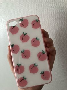 a person holding up a phone case with peaches on it