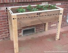 a wooden planter sitting next to a brick wall