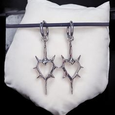 Gothic Thorn Heart Earrings - Korean Punk Charms for Women, Hip Hop Grunge Jewelry 📦 Processing Time: 5-7 days ✈ Shipping Time: 6-10 days Shipping: Free international shipping on all orders! Customer Satisfaction Guaranteed: If your earrings arrive damaged, we offer a full refund or replacement. Add a touch of rebellion to your jewelry collection with these striking Gothic Thorn Heart Earrings. Perfect for yourself or as a gift for someone who loves bold, alternative fashion! Questions? Feel fr Punk Metal Earrings For Concerts, Silver Punk Earrings For Concert, Punk Style Metal Earrings For Concert, Punk Heart-shaped Earrings, Punk Heart-shaped Pierced Earrings, Edgy Heart-shaped Pierced Jewelry, Edgy Pierced Earrings For Concerts, Punk Jewelry For Valentine's Day Concert, Heart-shaped Punk Jewelry For Concerts