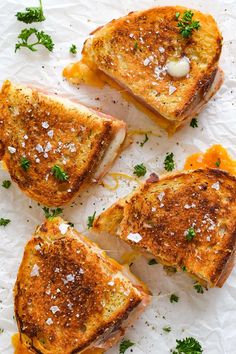 four grilled cheese sandwiches with parsley on top