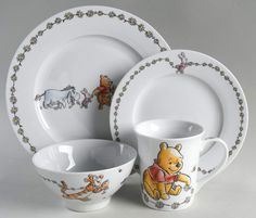 a winnie the pooh dinner set with plates, cups and saucers is shown