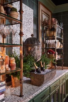 a kitchen counter topped with lots of pots and pans filled with wine bottle bottles