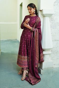 Burgundy maroon long anarkali with woven floral motifs scattered all-over and a thick border on the hem and sleeve hems. Comes with co-ordinating straight pant with a border on the hem and woven motifs dupatta.
Component: 3
Pattern: Woven
Type Of Work: Floral Motifs
Neckline: Round
Sleeve Type: Full
Fabric: Vegan Silk; Lining: Shantoon
Color: Maroon
Other Details: 
Dupatta with scattered floral woven motifs and thick border
Scallop trim on the hem
Show button detail on the concealed front placke Cloth Styling, Cloth Styles, College Clothing, Long Anarkali, Scallop Trim, Cute Winter Outfits, Love Clothing, Floral Motifs, Affordable Clothes