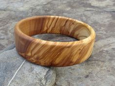 handmade Bracelet Bangle made out of fine olive wood Diameter inside 6,5 cm ( 2,56 inch) large 2 cm ( 0,79 inch) the olive wood is finely sanded and oiled with olive oil naturally the grain of the olive wood can vary from item to item , but in any case you will get a olive wood bracelet with beautiful grain This bangles are turned by us from a piece of olive wood. Handmade in Portugal In our Shop you can find more earrings , rings and necklaces made out of olive wood ! Natural Jewelry, Bangles Making, Wood Bracelet, Boho Christmas, Olive Tree, Earrings Rings, Bracelet Bangle, Handmade Bracelet, Olive Wood