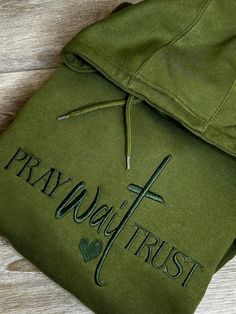 Pray Wait Trust beautifully embroidered sweatshirt  on Hanes Eco Friendly Soft Sweatshirt. Faith encouraging Embroidered Navy Green Hoodie.  -Sweatshirt true to size -Monochromatic Design  -Sweatshirt brand may vary depending on availability Any questions or concern please feel free to send me a message Fleece Hoodie Sweatshirt With Embroidered Graphics, Embroidered Fleece Hoodie Sweatshirt, Hooded Fleece Sweatshirt With Letter Embroidery, Crew Neck Fleece Hoodie With Letter Embroidery, Fleece Hoodie With Embroidered Text, Winter Hoodie With Custom Embroidery In Relaxed Fit, Cotton Hoodie With Embroidered Text And Long Sleeves, Casual Hoodie With Custom Embroidery In Relaxed Fit, Winter Fleece Hoodie With Embroidered Text