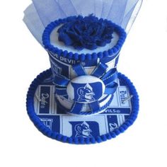 Cheer on the Blue Devils in this fancy mini top hat. Top hat covered with Duke fabric and coordinating trim and embellishments.  Show your team spirit at any tailgate party or on game day! Black elastic hat band attached. Approx size 4x6 Mini Top Hat, Duke Blue Devils, Mini Top, Blue Devil, Tailgate Party, Hat Band, Top Hat, Team Spirit, Game Day