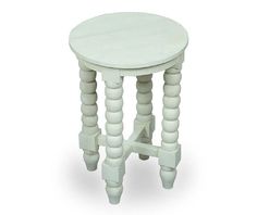 a small white table with wooden legs and a round top on an isolated white background