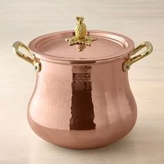 a large pot with handles on top of a table